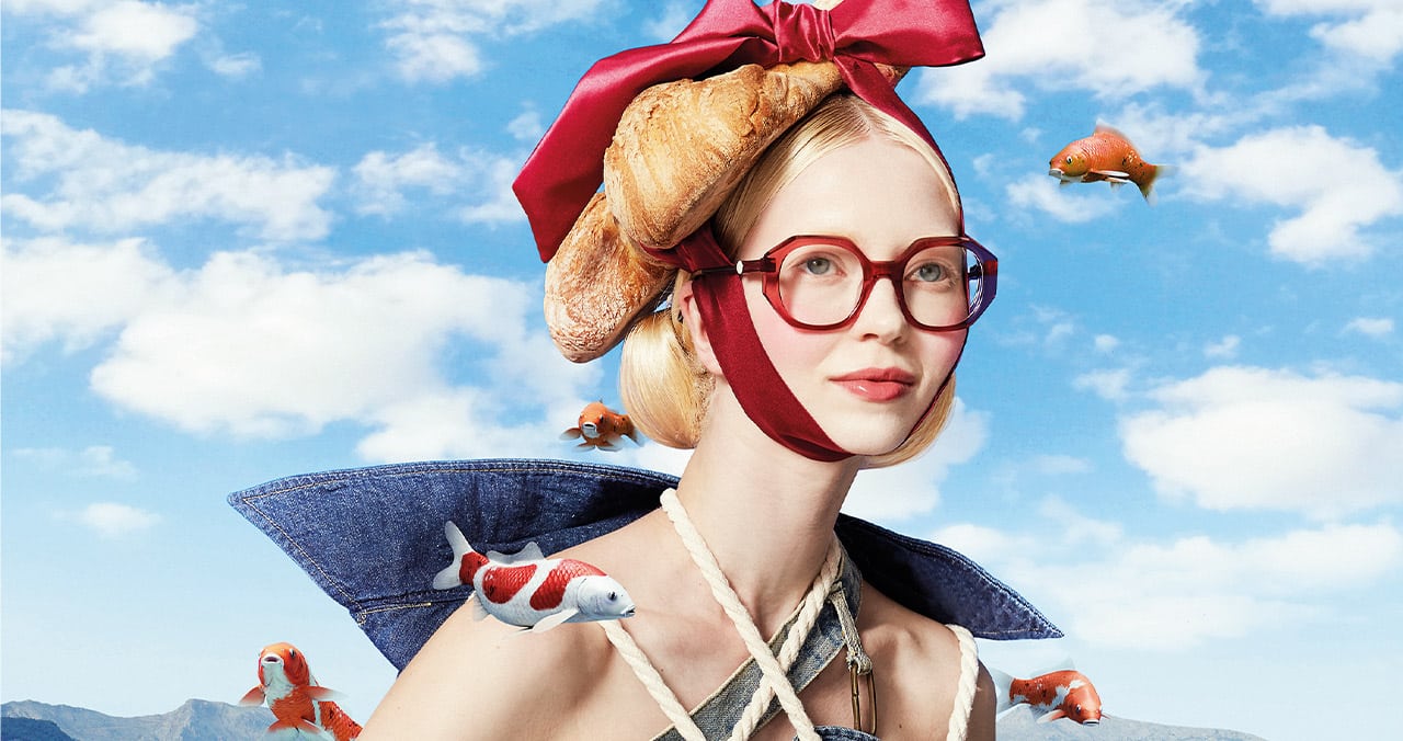 Mixed-media image of a woman wearing bold red Etnia Barcelona fashionable eyewear, with a whimsical croissant and bow headpiece.