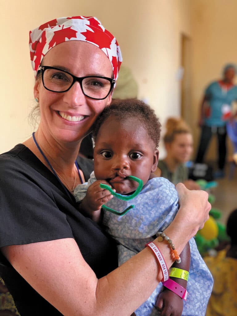 Eyecare professional Darcy Huda with a child during her volunteer work in Ghana